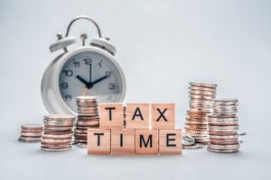 Reminder with a clock and message that it's time to sort business tax
