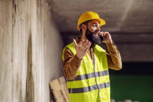 Stoke-on-Trent building contractor on site discussing building project over the phone